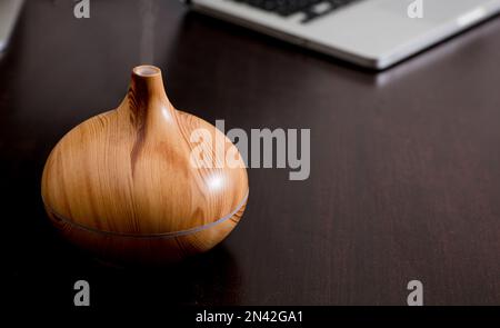 wood fragrance on desk table with steam essence of natural oils Stock Photo