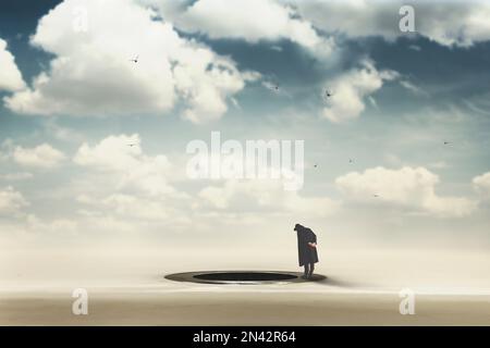 man curiously looks at a surreal hole built in the ground, abstract concept Stock Photo