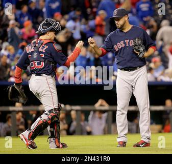 Boston Red Sox catcher CHRISTIAN VAZQUEZ talks with relief pitcher JUNICHI  TAZAWA