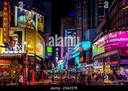 New York, USA - April 24, 2022: Times Square with tourists. Iconified as 'The Crossroads of the World' it's the brightly illuminated hub of the Broadw Stock Photo