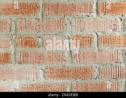 Background from a wall made of bleached brick with rough seams. Stock Photo