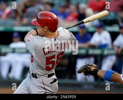 Texas Rangers' Kole Calhoun follows through on a run-scoring