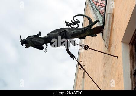 Aged gargoyle on old building facade in Kamianets-Podilskyi Ukraine Stock Photo