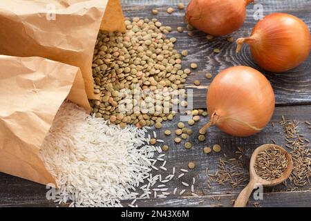 White rice, lentils, onions, zira or cumin - ingredients for traditional dish Middle Eastern food - mujaddara (mjaddra, mejadra, megadarra, mundardara Stock Photo