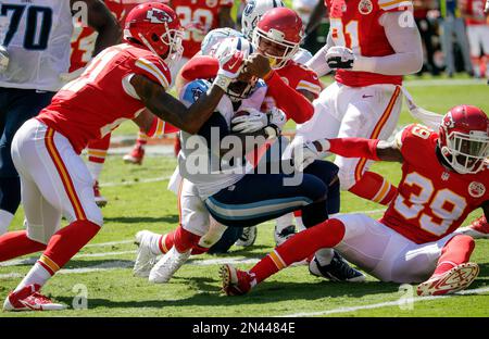 Wearing a New York Titans uniform, New York Jets quarterback Brett Favre,  center, stretches with teammate and running back Leon Washington before the  Jets faced the Cincinnati Bengals in East Rutherford, N.J.