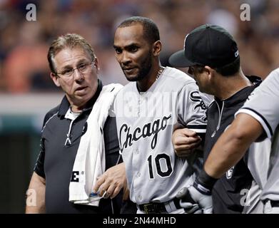 Chicago White Sox trainer Herman Schneider looks at second baseman