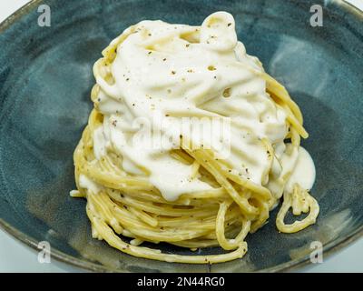 Spaghetti with four cheese sauce Italian style in a restaurant Stock Photo