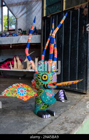 Fire-breathing alebrije creaature in an artisan's shop / workshop in San Antonio Arrazola, Oaxaca, Mexico.  Alebrijes are colorful painted creatures r Stock Photo