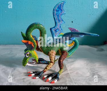 An alebrije dragon in an artisan's shop / workshop in San Antonio Arrazola, Oaxaca, Mexico.  Alebrijes are colorful painted creatures related to the D Stock Photo