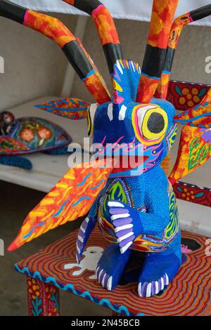 Fire-breathing alebrije creaature in an artisan's shop / workshop in San Antonio Arrazola, Oaxaca, Mexico.  Alebrijes are colorful painted creatures r Stock Photo