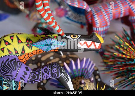 An alebrije dragon in an artisan's shop / workshop in San Antonio Arrazola, Oaxaca, Mexico.  Alebrijes are colorful painted creatures related to the D Stock Photo