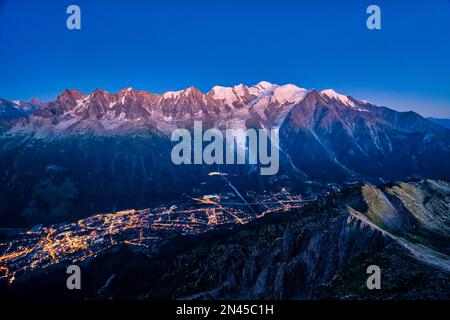 Aerial view on the town of Chamonix and the Mont Blanc massif, seen from Le Brevent at night. Stock Photo