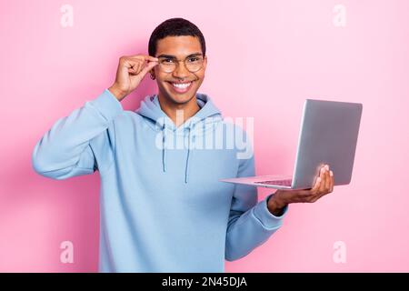 Photo of professional programmer it developer young guy wear stylish computer glasses hold laptop remote freelance isolated on pink color background Stock Photo