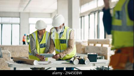 Engineer, architect and business people on tablet for construction, strategy or project plan at work. Team of contractors working together on Stock Photo