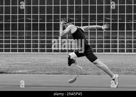 athlete runner disabled running on track black and white photo Stock Photo