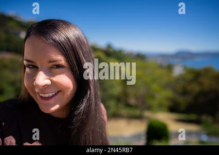 Beautiful girl brushing hair, model styling black hair getting ready to go out to an event in australia Stock Photo