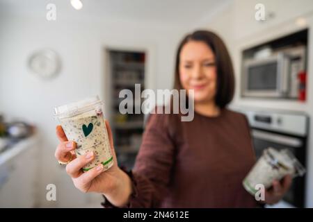 Getting food out of the fridge. Beer in the fridge. Fridge full of food. Freezer full of food. Person deciding what they what for dinner from the frid Stock Photo