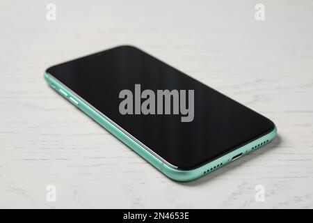 MYKOLAIV, UKRAINE - JULY 10, 2020: New modern Iphone 11 with on white wooden table Stock Photo