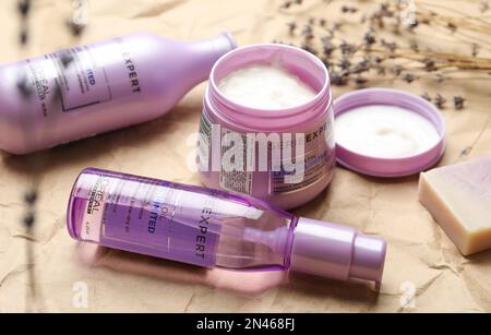 MYKOLAIV, UKRAINE - AUGUST 08, 2020: Set of L'Oreal hair care cosmetic products on crumpled paper Stock Photo