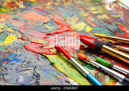 Set of brushes with different paints on artwork, closeup. Space for text  Stock Photo - Alamy