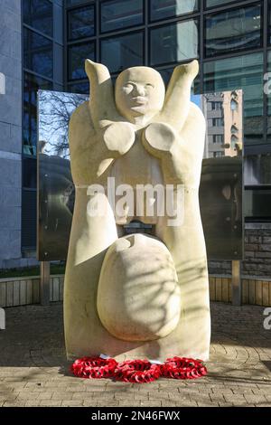 Hope is the title of Frances May Favata’s large stone sculpture at the University of Plymouth. A child is depicted being raised to the sky as a symbol Stock Photo