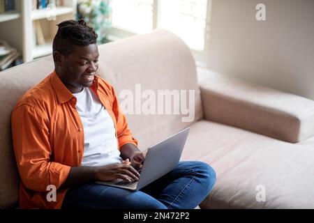 High angle view of black guy freelancer working from home Stock Photo