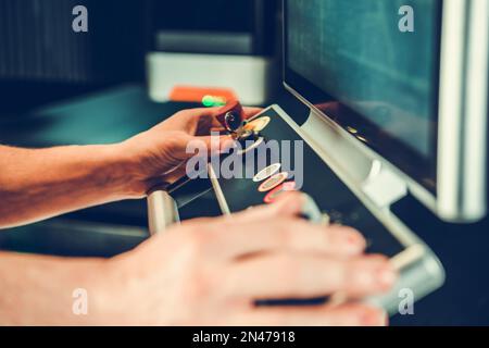 Digitally Operated Laser Cutter Console Operated by Caucasian Professional Technician Worker Close Up. Metalworking Industry Equipment. Stock Photo