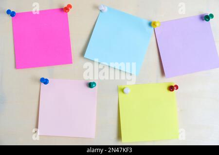 Colorful stickers for written notes are fixed plywood board Stock Photo