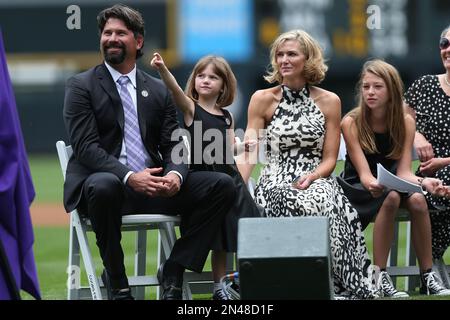 After being given a gelding paint horse as a retirement present, Colorado  Rockies first baseman Todd Helton, right, joins his daughter Tierney Faith,  second from right, and his wife Christy and d …