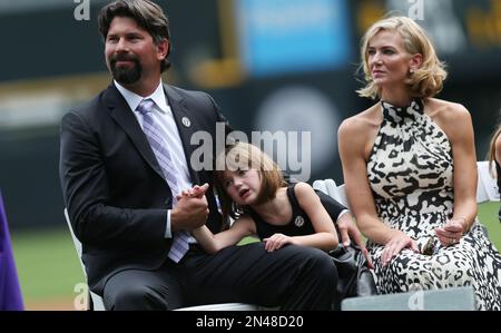 Colorado Rockies first baseman Todd Helton, right, gets a kiss from his  youngest daughter Gentry Grace and as his wife Christy holds her following  a news conference announcing his retirement from baseball