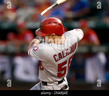 Texas Rangers' Kole Calhoun follows through on a run-scoring