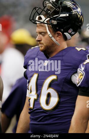 Baltimore Ravens long snapper Morgan Cox (46) waits to take the field while  holding a flag as part of the team's Salute to Service prior to an NFL  football game against the