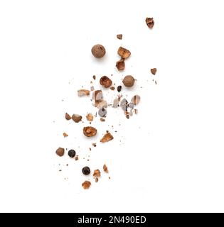 Whole and broken allspice pieces falling and isolated on white, top view Stock Photo