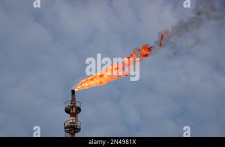 Noxes burning with a flame from an industrial chimney in Sines - Portugal Stock Photo