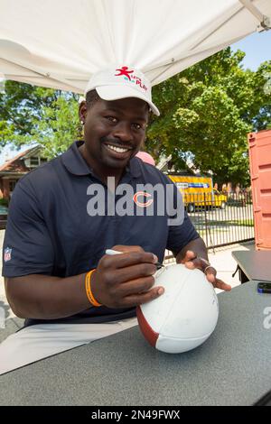 Chicago Bears' Alex Brown, top, dances over Green Bay Packers