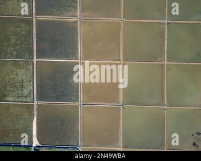 Aerial drone view of Salt Fields in Solana Pag, the largest sea-salt producer in Croatia, and its operations are based on a thousand-year tradition. Stock Photo