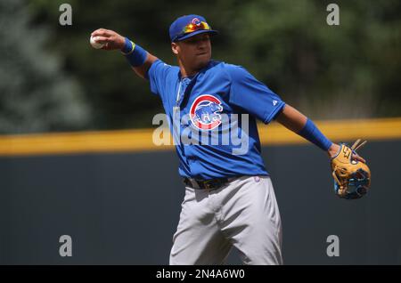 Chicago Cubs' Javier Baez, left, slides into second base safely as he hit a  one-run double as Colorado Rockies second baseman DJ LeMahieu (9) makes a  late tag during the eighth inning