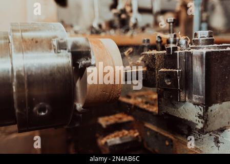 Close-up photo of a lathe working on wood. Mechanical processing of wood Stock Photo