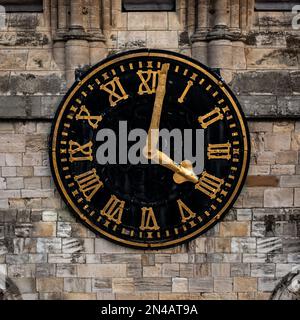 Close up of the face and hands of a traditional church clock on a clock tower in a square frame Stock Photo