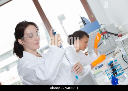 two young female scientist doing experiments in lab Stock Photo