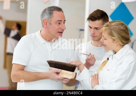 portrait of apprentices learning about brushes Stock Photo