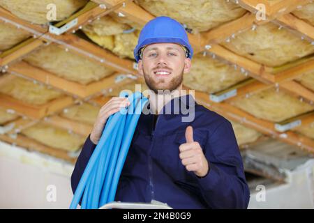 portrait of smiling electrician with cable coil Stock Photo