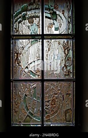 Colorful textures on the glass of a window highlighted from outside Stock Photo
