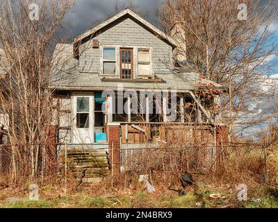 An abandoned house in Highland Park is being overcome by plants and bushes. Stock Photo
