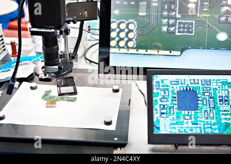 Electronic boards and chips, industrial microscope and monitors Stock Photo