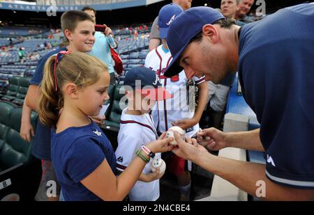 Jeff Francoeur, a player for the Atlanta Braves signs an autograph for a  military family member during a luncheon at Fort Bragg, N.C., July 3, 2016.  The event is a part of