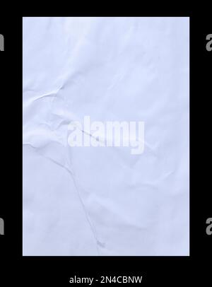Blank white crumpled and creased sticker glued paper poster texture isolated on black background. Stock Photo