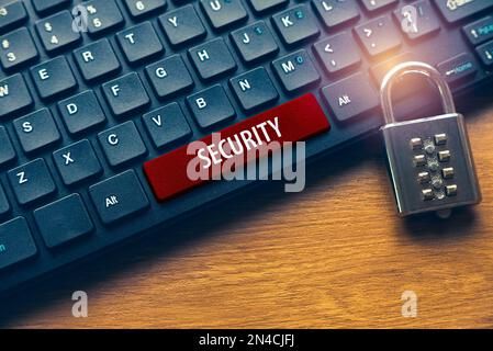 Padlock and computer keyboard with red button written with Security. Stock Photo