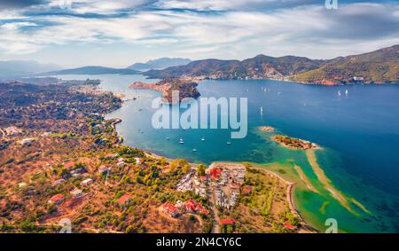 Spectacular summer view of Plaka beach and Poros town on background. Breathtaking morning seascape of Mediterranean sea with a lots of yachts. Wonderf Stock Photo