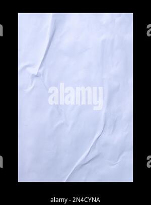 Blank white crumpled and creased sticker glued paper poster texture isolated on black background. Stock Photo